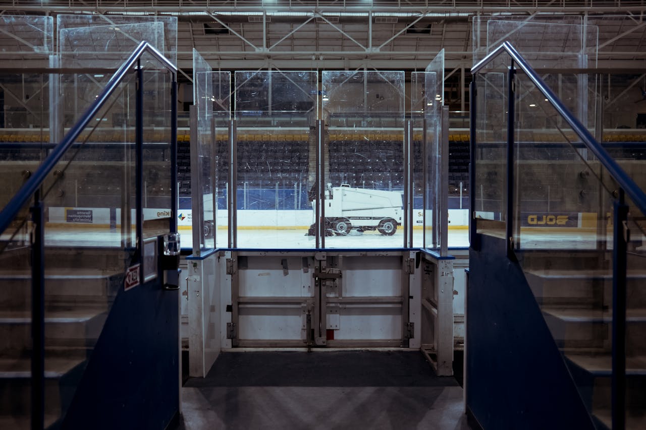 about-01 View of an ice resurfacer on an empty ice rink in a quiet sports stadium.