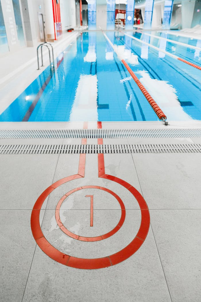 home-services-01 Bright indoor swimming pool featuring lanes and numbered starting point for competitive training.